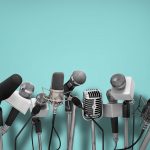 Several microphones against a blue background