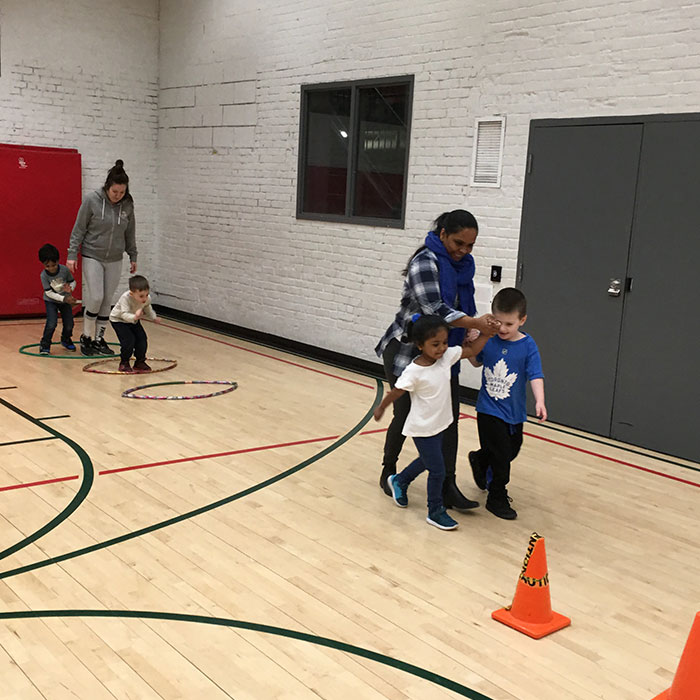 Children and parents playing in an indoor gym