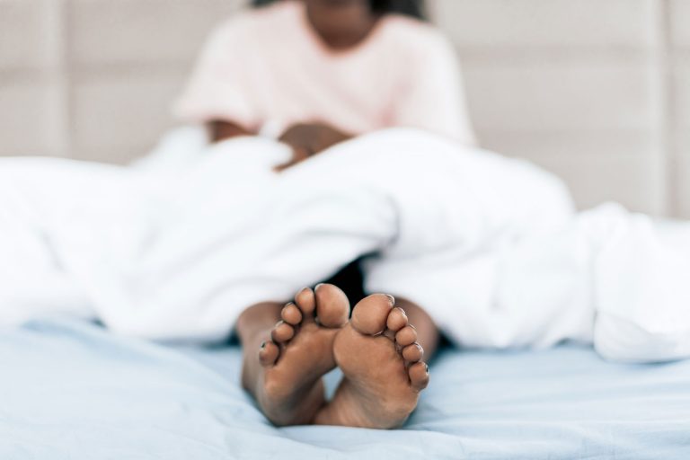 A view of a patients feet who is sitting in bed